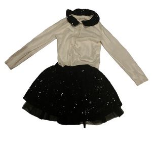 Long sleeved  sweater with black sequence skirt.